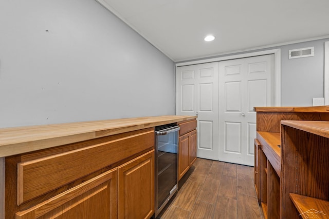 1449 Sauk Ln, Saginaw, MI 48638 - kitchen with wood counters, wine cooler, dark wood-style flooring, brown cabinets, and recessed lighting