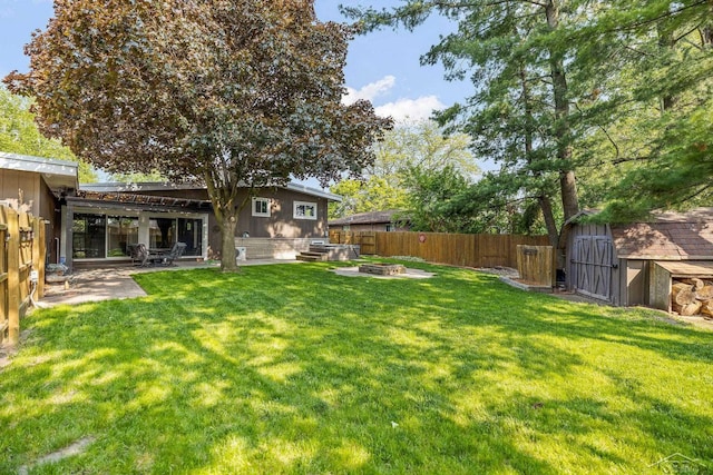 1449 Sauk Ln, Saginaw, MI 48638 - fenced backyard featuring a shed, a patio, and a fire pit