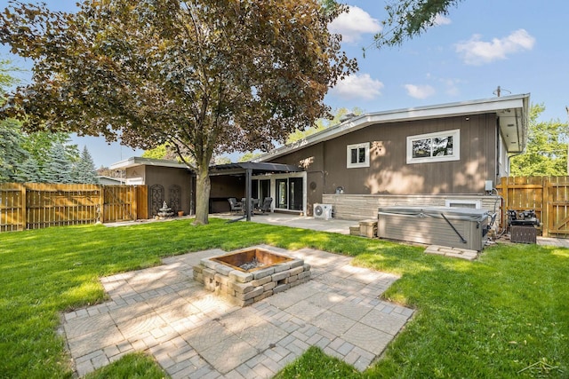 1449 Sauk Ln, Saginaw, MI 48638 - back of property with a hot tub, an outdoor fire pit, a patio, a fenced backyard, and a pergola