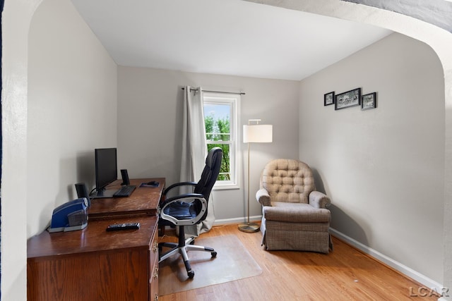 1104 Sunset Dr, Tecumseh, MI 49286 - office with arched walkways, light wood finished floors, and baseboards