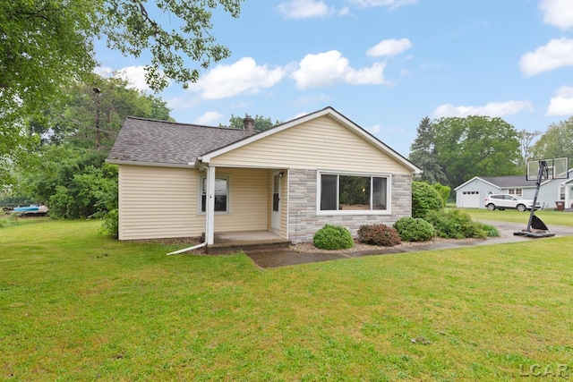 1104 Sunset Dr, Tecumseh, MI 49286 - ranch-style home featuring a front lawn, a porch, stone siding, a chimney, and a shingled roof