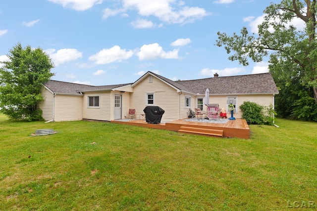 1104 Sunset Dr, Tecumseh, MI 49286 - back of property with a lawn and a deck