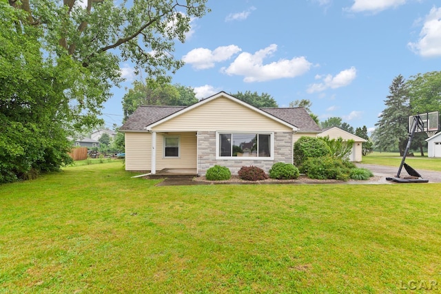 1104 Sunset Dr, Tecumseh, MI 49286 - view of front of home featuring stone siding, a front yard, and driveway