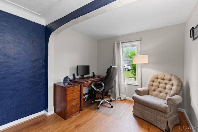 1104 Sunset Dr, Tecumseh, MI 49286 - office featuring wood finished floors, arched walkways, and baseboards