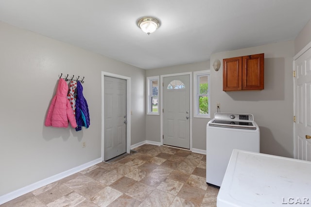 1104 Sunset Dr, Tecumseh, MI 49286 - washroom with baseboards, stone finish floors, cabinet space, and washer and clothes dryer