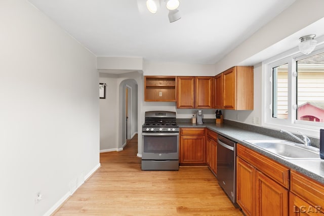 1104 Sunset Dr, Tecumseh, MI 49286 - kitchen with stainless steel appliances, a sink, open shelves, dark countertops, and light wood-style flooring