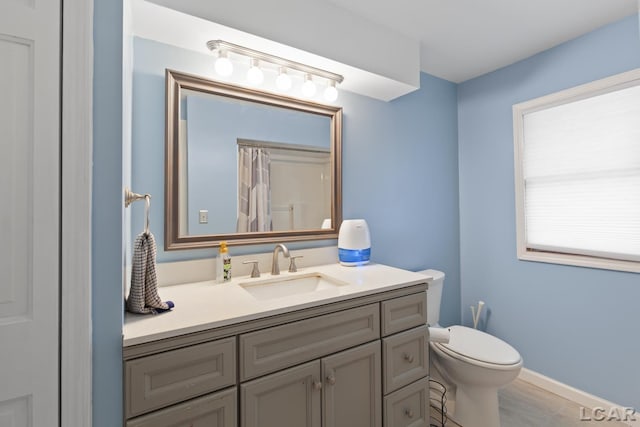 1104 Sunset Dr, Tecumseh, MI 49286 - bathroom featuring vanity, toilet, and a shower with curtain