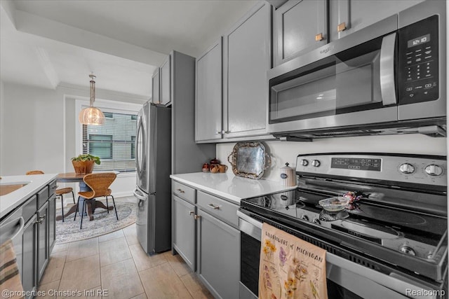15 E Kirby St Unit 304, Detroit, MI 48202 - kitchen featuring stainless steel appliances, gray cabinets, light countertops, and hanging light fixtures