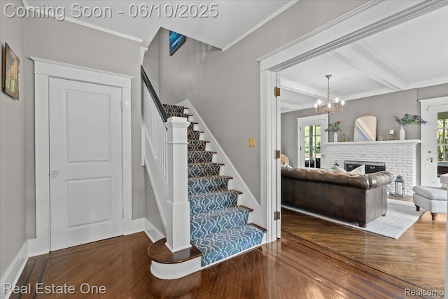 22 Elm Park Blvd, Pleasant Ridge, MI 48069 - stairs with wood finished floors, beamed ceiling, crown molding, a chandelier, and a brick fireplace