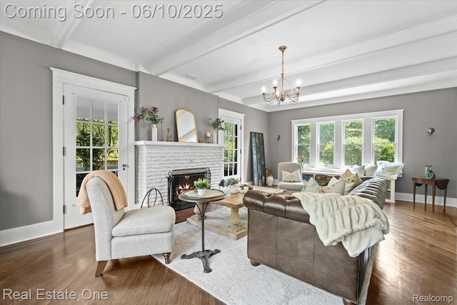 22 Elm Park Blvd, Pleasant Ridge, MI 48069 - living area featuring wood finished floors, beam ceiling, baseboards, a brick fireplace, and a chandelier