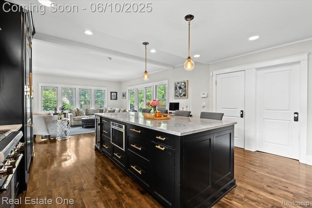 22 Elm Park Blvd, Pleasant Ridge, MI 48069 - kitchen featuring dark cabinetry, open floor plan, dark wood-style floors, pendant lighting, and crown molding