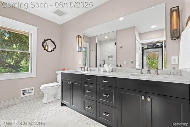 22 Elm Park Blvd, Pleasant Ridge, MI 48069 - bathroom with double vanity, toilet, a stall shower, baseboards, and recessed lighting