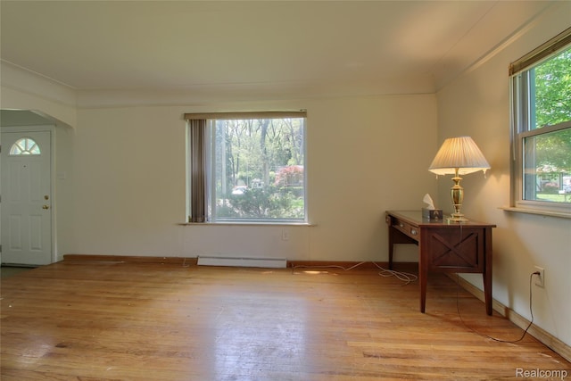 21248 Hamilton Ave, Farmington Hills, MI 48336 - entrance foyer featuring light wood-type flooring, a baseboard radiator, arched walkways, and baseboards