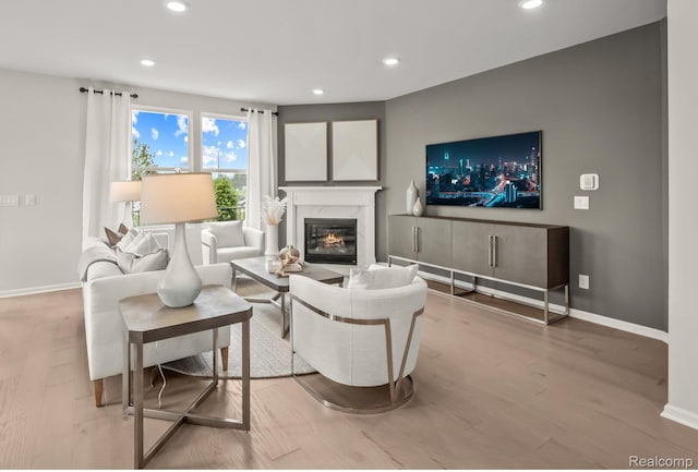 3013 Sheffield Cir, Clarkston, MI 48346 - living room featuring recessed lighting, baseboards, wood finished floors, and a high end fireplace