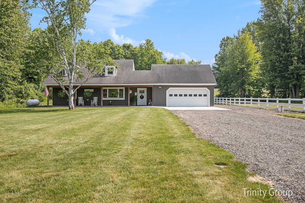 1036 Quincy St, Grandville, MI 49418 - view of front of property featuring a garage, driveway, and a porch