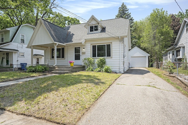 1831 Newark Ave SE, Grand Rapids, MI 49507 - view of front facade featuring covered porch, an outbuilding, a garage, a shingled roof, and driveway