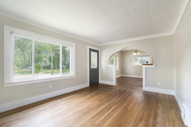 1831 Newark Ave SE, Grand Rapids, MI 49507 - entryway featuring arched walkways, hardwood / wood-style flooring, baseboards, and a textured ceiling