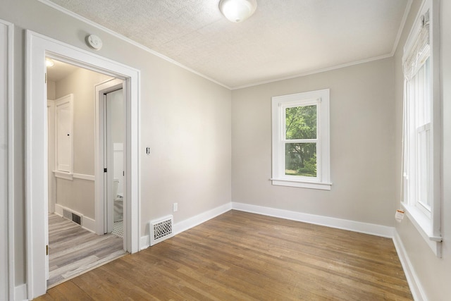 1831 Newark Ave SE, Grand Rapids, MI 49507 - spare room featuring wood finished floors, baseboards, ornamental molding, and a smoke detector