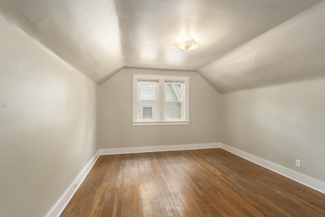 1831 Newark Ave SE, Grand Rapids, MI 49507 - bonus room featuring dark wood-style flooring, vaulted ceiling, and baseboards