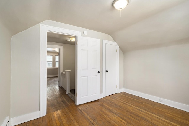1831 Newark Ave SE, Grand Rapids, MI 49507 - bonus room with dark wood-style flooring, vaulted ceiling, baseboards, and a baseboard heating unit
