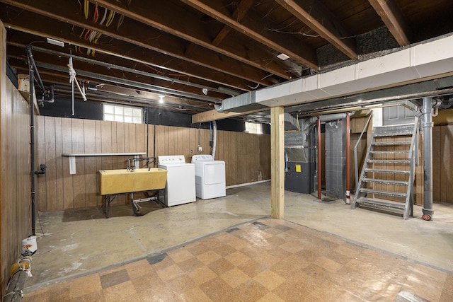 1831 Newark Ave SE, Grand Rapids, MI 49507 - below grade area featuring washing machine and dryer, a sink, wood walls, stairs, and heating unit
