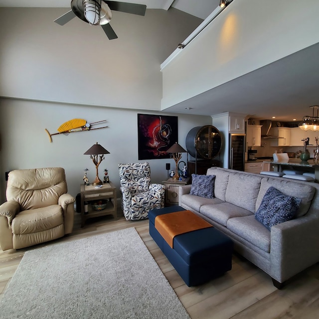 144 Dunkley Ave Unit 4, South Haven, MI 49090 - living room featuring beverage cooler, ceiling fan, light wood-type flooring, and a high ceiling