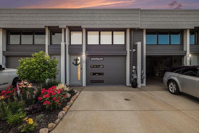 144 Dunkley Ave Unit 4, South Haven, MI 49090 - view of exterior entry featuring concrete driveway and an attached garage