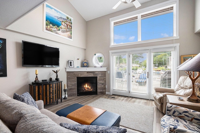 144 Dunkley Ave Unit 4, South Haven, MI 49090 - living room with wood finished floors, a fireplace, high vaulted ceiling, and ceiling fan