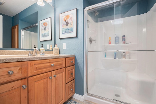 144 Dunkley Ave Unit 4, South Haven, MI 49090 - bathroom featuring a stall shower, vanity, and a textured wall