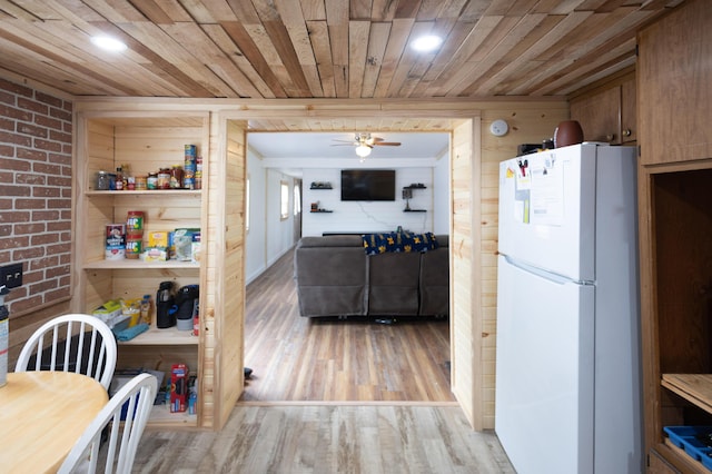425 Clinton St, Mendon, MI 49072 - kitchen with freestanding refrigerator, wooden ceiling, ceiling fan, light wood-style floors, and wood walls