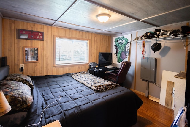 425 Clinton St, Mendon, MI 49072 - bedroom featuring wood walls, dark wood-type flooring, electric panel, and baseboards
