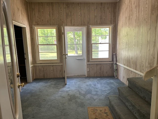 5649 W 76th St, Baldwin, MI 49304 - entryway featuring carpet, stairs, and wooden walls