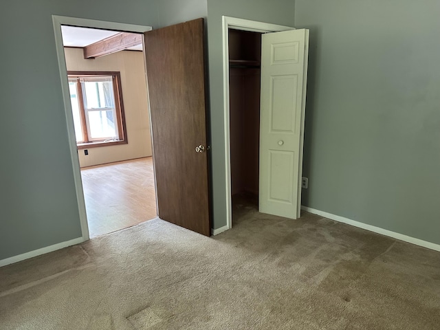5649 W 76th St, Baldwin, MI 49304 - unfurnished bedroom featuring carpet floors, baseboards, and a closet