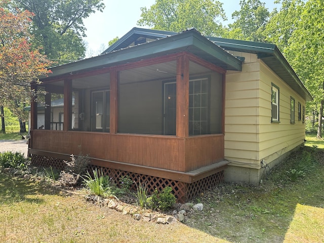 5649 W 76th St, Baldwin, MI 49304 - view of home's exterior with a sunroom