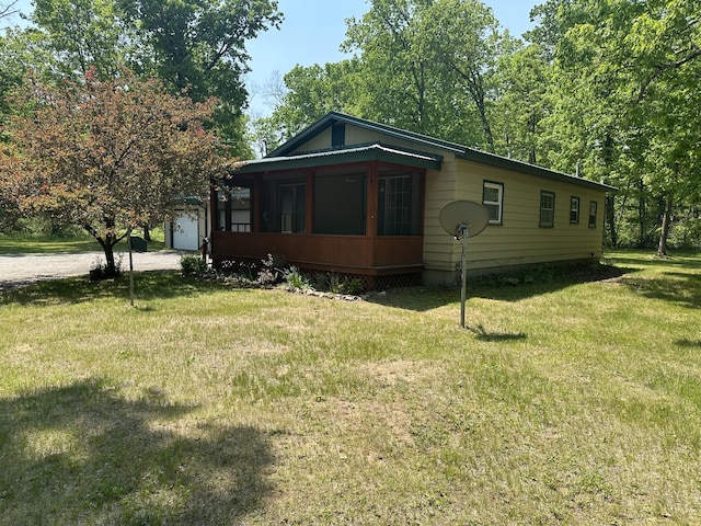 5649 W 76th St, Baldwin, MI 49304 - view of front facade featuring a front yard and driveway