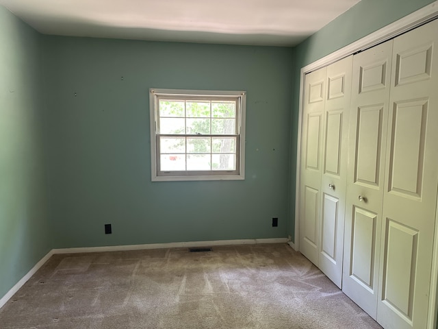 5649 W 76th St, Baldwin, MI 49304 - unfurnished bedroom with carpet, a closet, and baseboards