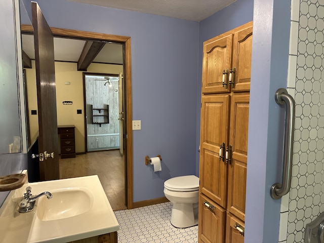 5649 W 76th St, Baldwin, MI 49304 - bathroom featuring toilet, vanity, and baseboards
