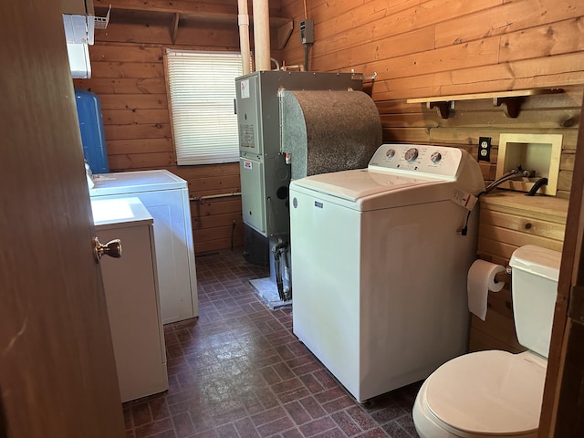 5649 W 76th St, Baldwin, MI 49304 - laundry room featuring wooden walls, washing machine and dryer, brick patterned flooring, and heating unit