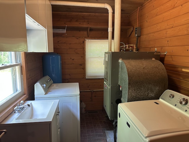 5649 W 76th St, Baldwin, MI 49304 - washroom featuring wood walls, separate washer and dryer, and brick patterned flooring