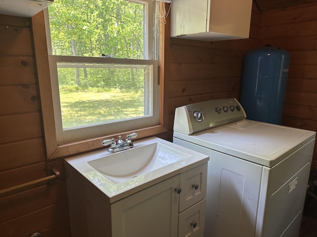 5649 W 76th St, Baldwin, MI 49304 - laundry area featuring washer / dryer, wood walls, and a sink