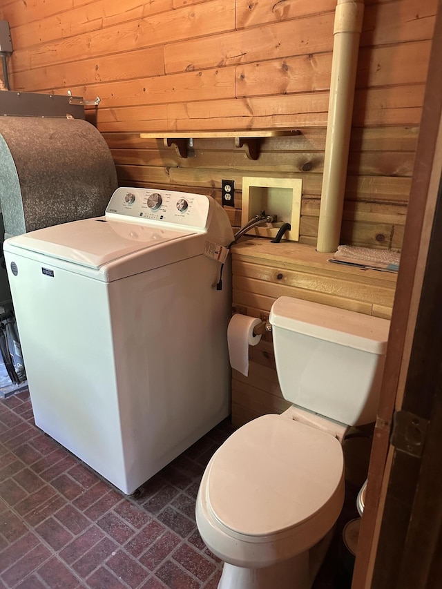 5649 W 76th St, Baldwin, MI 49304 - half bath featuring washer / clothes dryer, wood walls, brick patterned flooring, and toilet