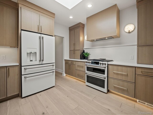 1756 Alexander Dr, Bloomfield Hills, MI 48302 - kitchen featuring white refrigerator with ice dispenser, range with two ovens, light countertops, light wood-style floors, and recessed lighting