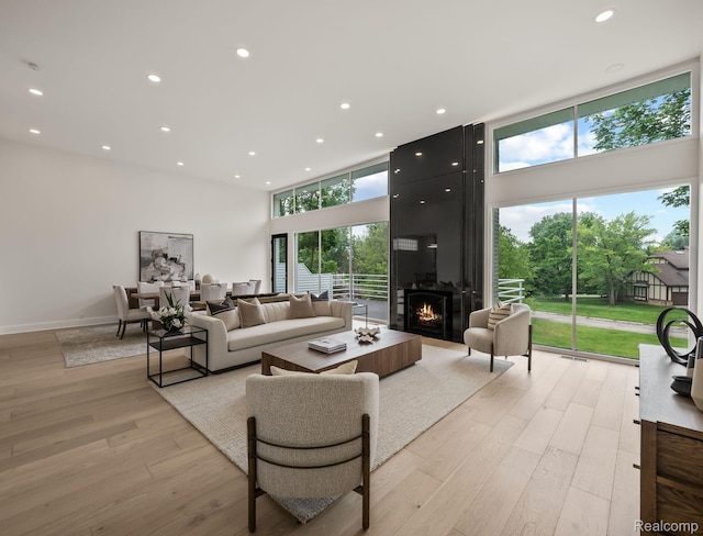 1756 Alexander Dr, Bloomfield Hills, MI 48302 - living area featuring a high ceiling, plenty of natural light, light wood-style flooring, recessed lighting, and a large fireplace