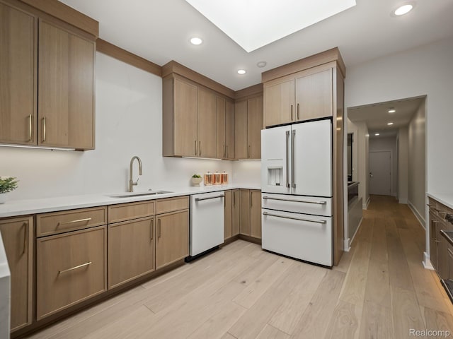 1756 Alexander Dr, Bloomfield Hills, MI 48302 - kitchen with white appliances, a sink, light wood-style floors, recessed lighting, and light countertops