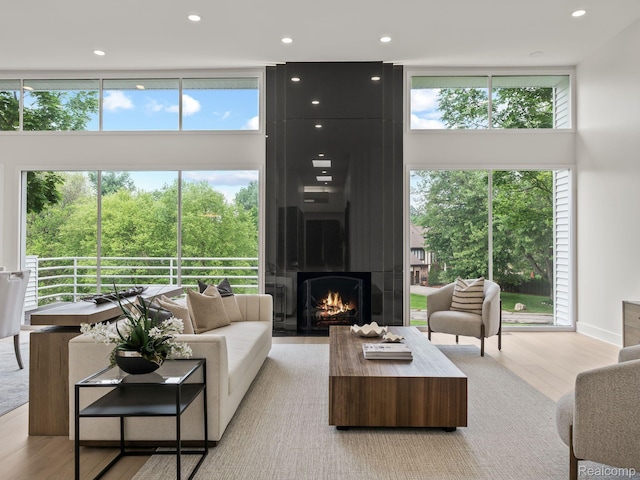 1756 Alexander Dr, Bloomfield Hills, MI 48302 - living area featuring a towering ceiling, plenty of natural light, light wood finished floors, recessed lighting, and a large fireplace