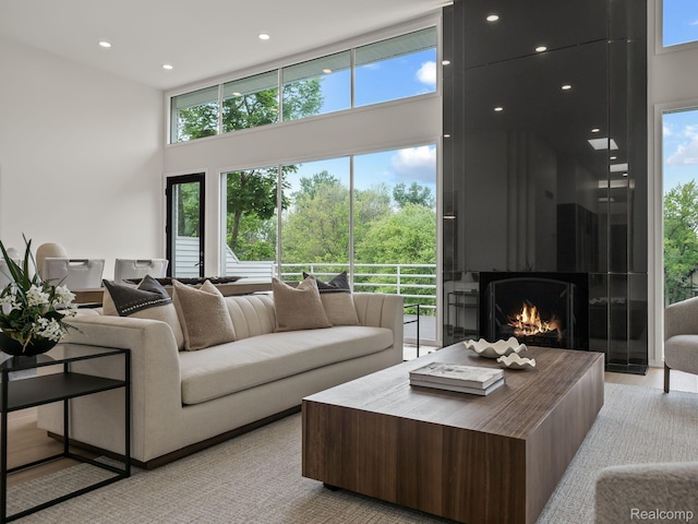 1756 Alexander Dr, Bloomfield Hills, MI 48302 - living area featuring a towering ceiling, a large fireplace, and recessed lighting