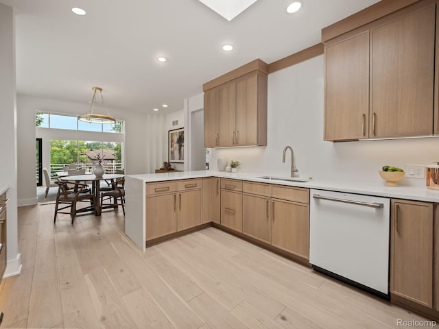 1756 Alexander Dr, Bloomfield Hills, MI 48302 - kitchen with a sink, white dishwasher, a peninsula, light countertops, and light wood-style floors