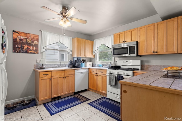 3128 Woodside Dr, Dearborn, MI 48124 - kitchen featuring white appliances, a sink, a ceiling fan, tile counters, and light tile patterned flooring