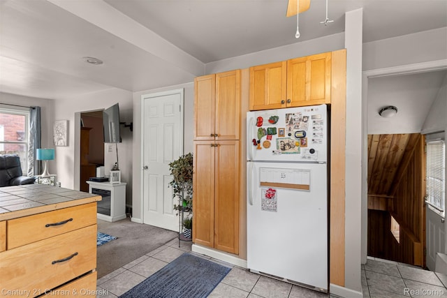3128 Woodside Dr, Dearborn, MI 48124 - kitchen featuring freestanding refrigerator, tile countertops, light tile patterned floors, baseboards, and light brown cabinets