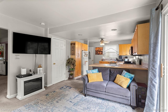 3128 Woodside Dr, Dearborn, MI 48124 - living room featuring light carpet, baseboards, and ceiling fan